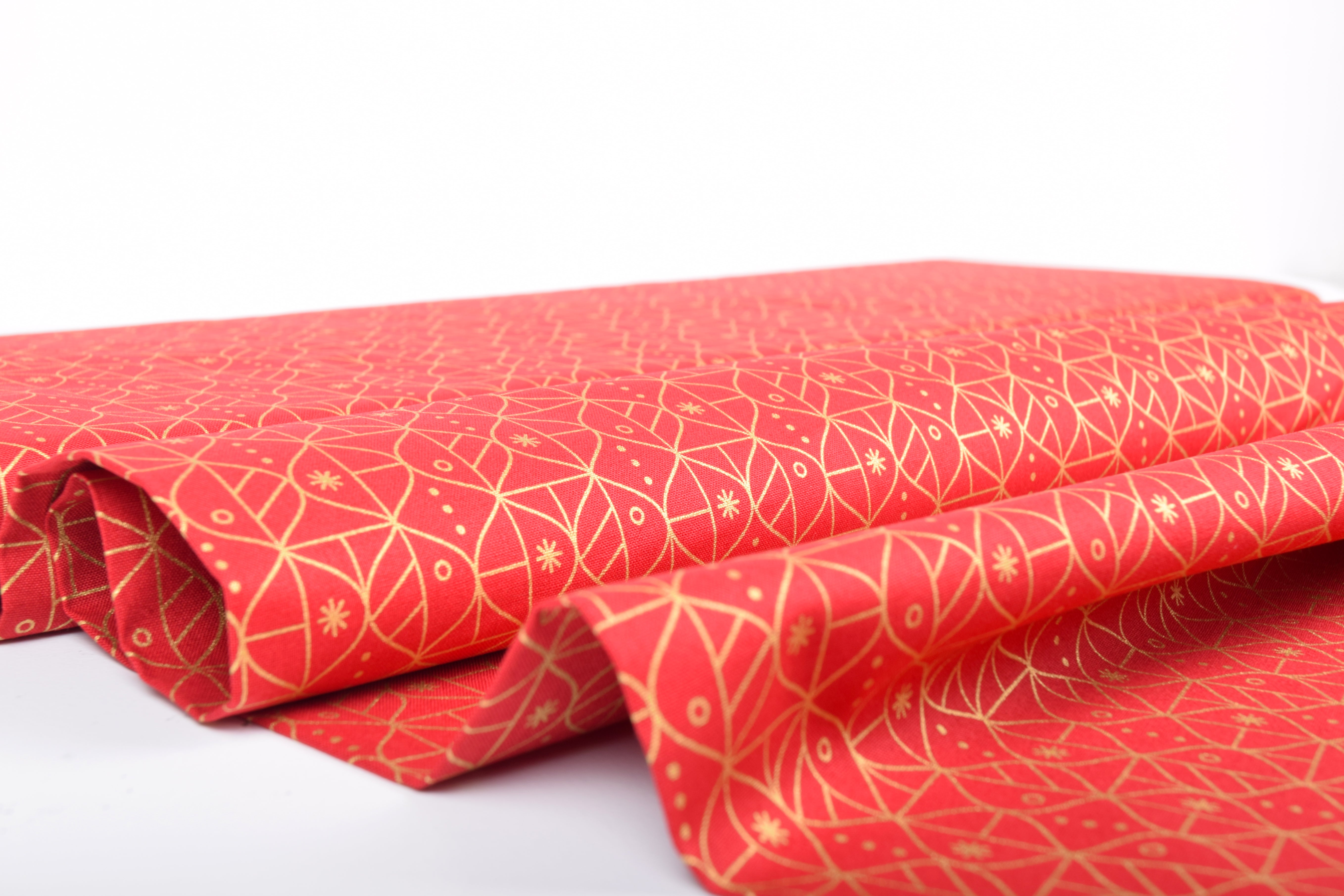 Red fabric with geometric pattern on a white background
